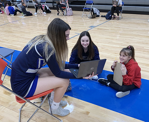 photo of three girls talking about their writing 